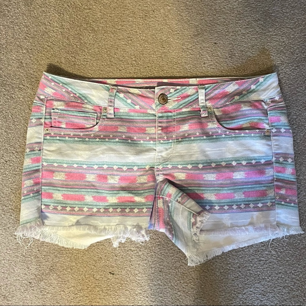 geometric print blue jean shorts with fringe legs